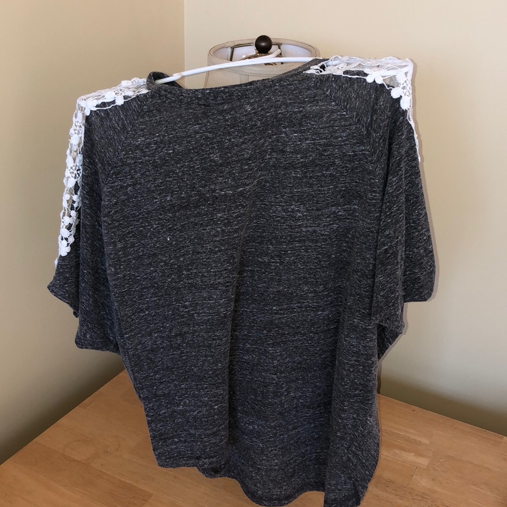 Gray tee with open floral design on shoulders